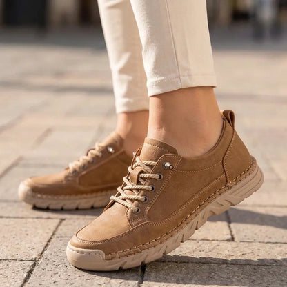 StitchStride tan brown stitched lace-up comfort sneakers worn with cream trousers